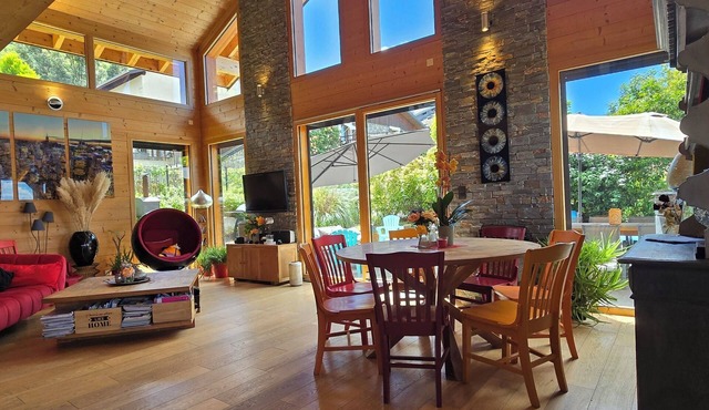 Wooden house between lake and mountains with indoor pool